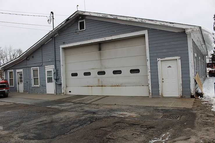 Blue Public Works Building with white doors.